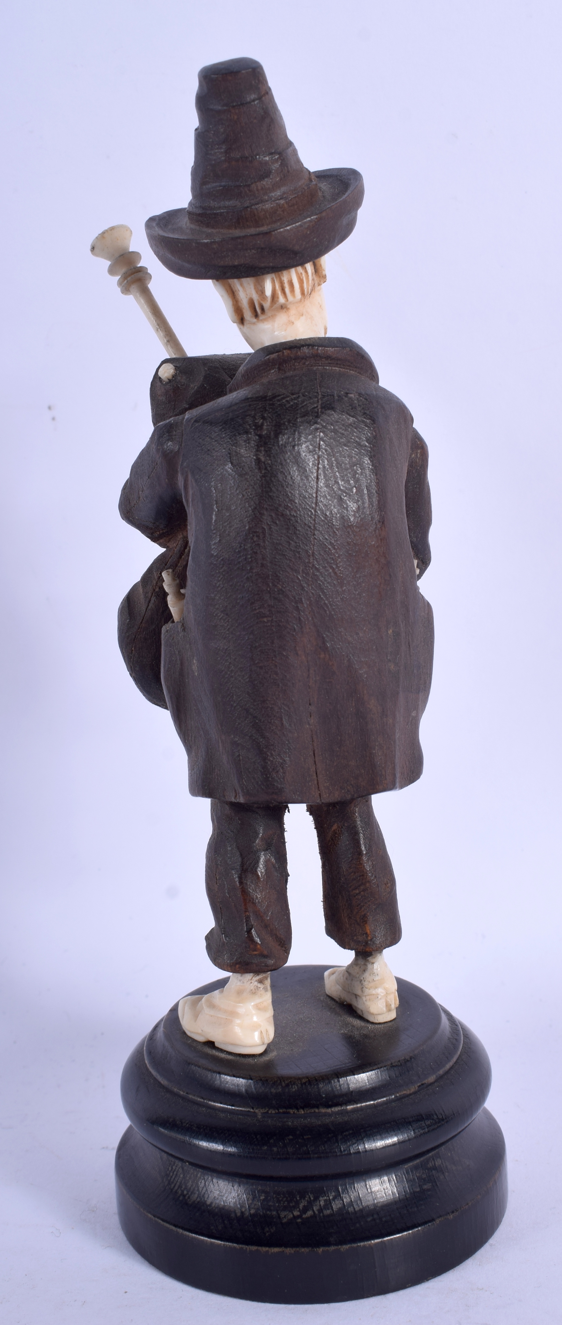 A 19TH CENTURY BAVARIAN CARVED WOOD BLACK FOREST MUSICIAN modelled playing bag pipes. 18 cm high. - Image 2 of 2