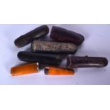 TWO AMBER CHEROOT HOLDERS, together with five cases. (7)