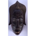 A GABONESE WOODEN PUNU MASK, carved with scarification marks. 32 cm x 14 cm.