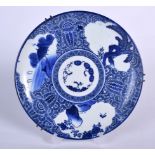 A JAPANESE BLUE AND WHITE PORCELAIN DISH, decorated with landscape scenery in panels,. 22.5 cm wide