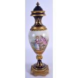 A 19TH CENTURY FRENCH SEVRES PORCELAIN VASE AND COVER painted with figures within landscapes. 28 cm