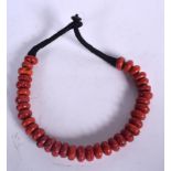 A RED CORAL NECKLACE, formed with flattened beads. 44 cm long.