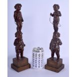 A PAIR OF 19TH CENTURY CONTINENTAL CARVED WOOD FIGURE OF PUTTI modelled upon square form bases. 35.