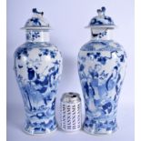 A PAIR OF 19TH CENTURY CHINESE BLUE AND WHITE VASES AND COVERS. 38 cm high.
