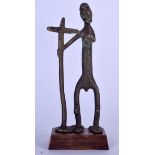 A BENIN BRONZE FIGURE OF AN ELONGATED MALE, modelled holding a cross. 21 cm high.