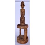 A WEST AFRICAN WOODEN TRIBAL STATUE, formed as a kneeling male upon aa two tier plinth. 58 cm high.
