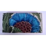 A 19TH CENTURY ENGLISH WILLIAM DE MORGAN FAIENCE IZNIK TILE painted with flowers. 15.5 cm x 8 cm.