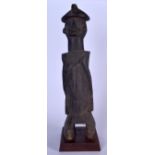 A LARGE AFRICAN CARVED WOODEN STATUE, formed upon a plinth. 60 cm high.