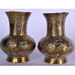 A PAIR OF EARLY 20TH CENTURY INDIAN BRASS VASE, decorated in relief with figures in various pursuit