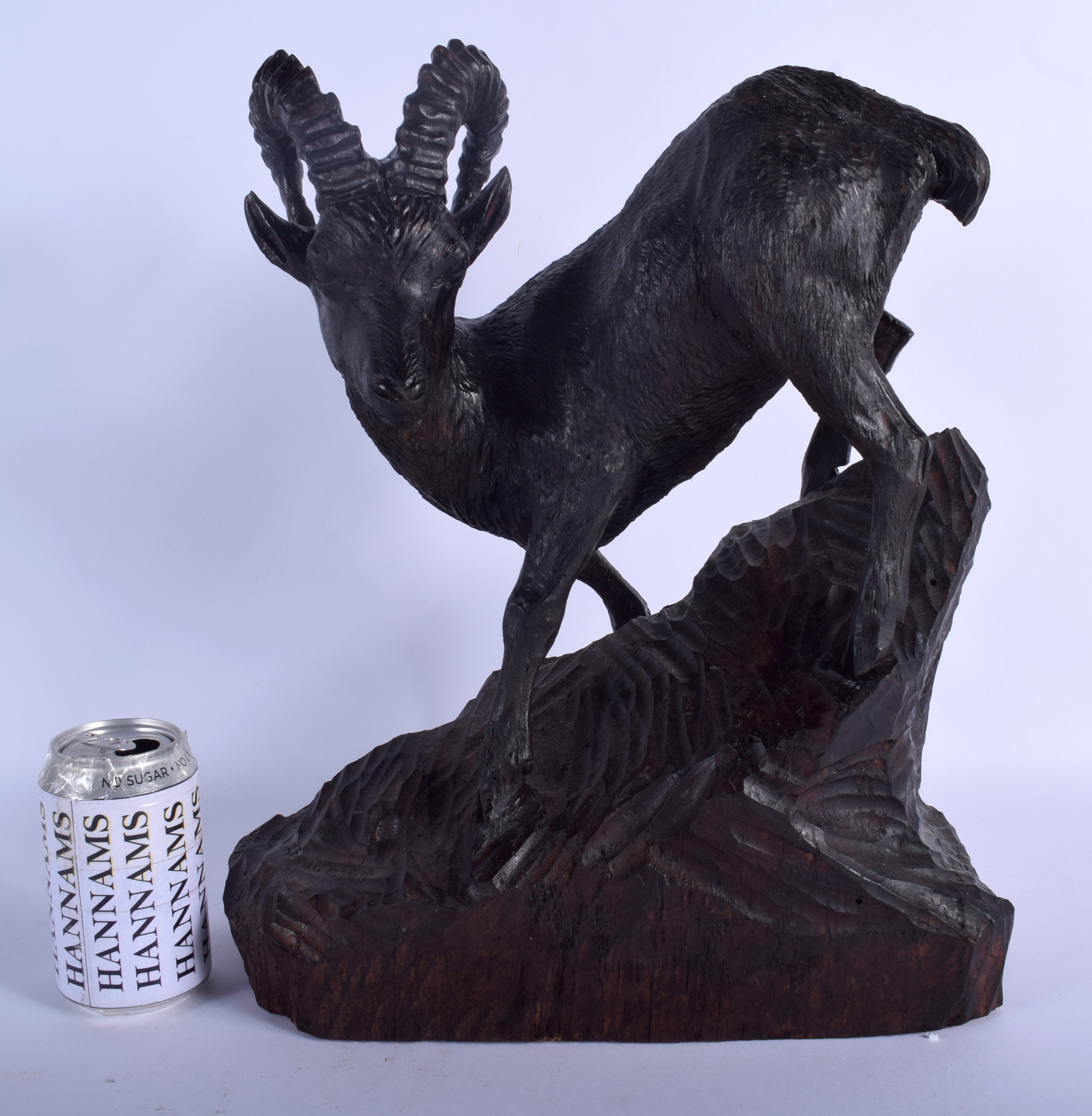 A LARGE ANTIQUE BAVARIAN BLACK FOREST STANDING STAG IBEX modelled upon a naturalistic base. 44 cm x