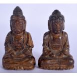 A SMALL RARE PAIR OF 18TH/19TH CENTURY KOREAN JOSEON DYNASTY CARVED WOOD BUDDHA modelled seated wit