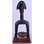 A GURO / DAN CARVED WOODEN HEDDLE PULLEY, in the form of a female. 26 cm high.
