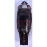 AN IVORY COAST GURU CARVED WOODEN MASK, formed as a gazelle like animal with fangs. 48 cm x 13 cm.