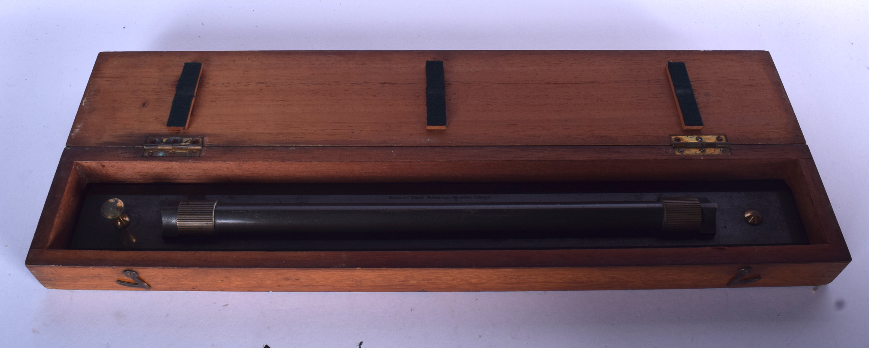 AN ANTIQUE ROLLING RULER, in mahogany case. 49 cm wide.