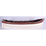 A VINTAGE WOODEN BOAT, with associated oars, painted white. 62 cm wide.