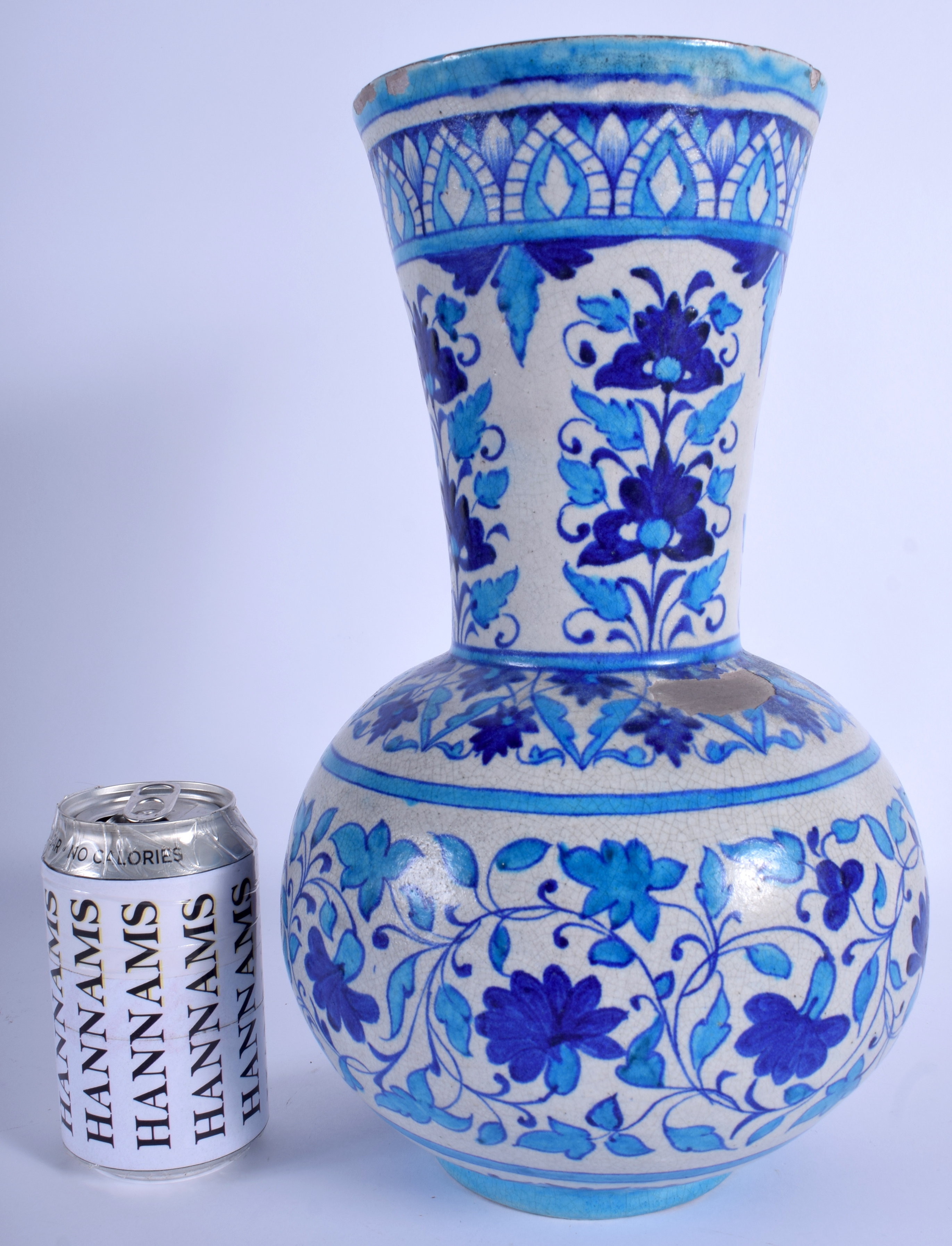 A LARGE PERSIAN MIDDLE EASTERN ISLAMIC FAIENCE BLUE VASE painted with flowers. 34 cm high.