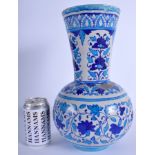 A LARGE PERSIAN MIDDLE EASTERN ISLAMIC FAIENCE BLUE VASE painted with flowers. 34 cm high.
