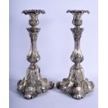 A PAIR OF ANTIQUE CONTINENTAL SILVER CANDLESTICKS of rococo form. 32 cm high.