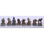 SEVEN CHINESE BRONZE SEALS, together with a bronze buddha pendant. Largest 3.25 cm high. (8)