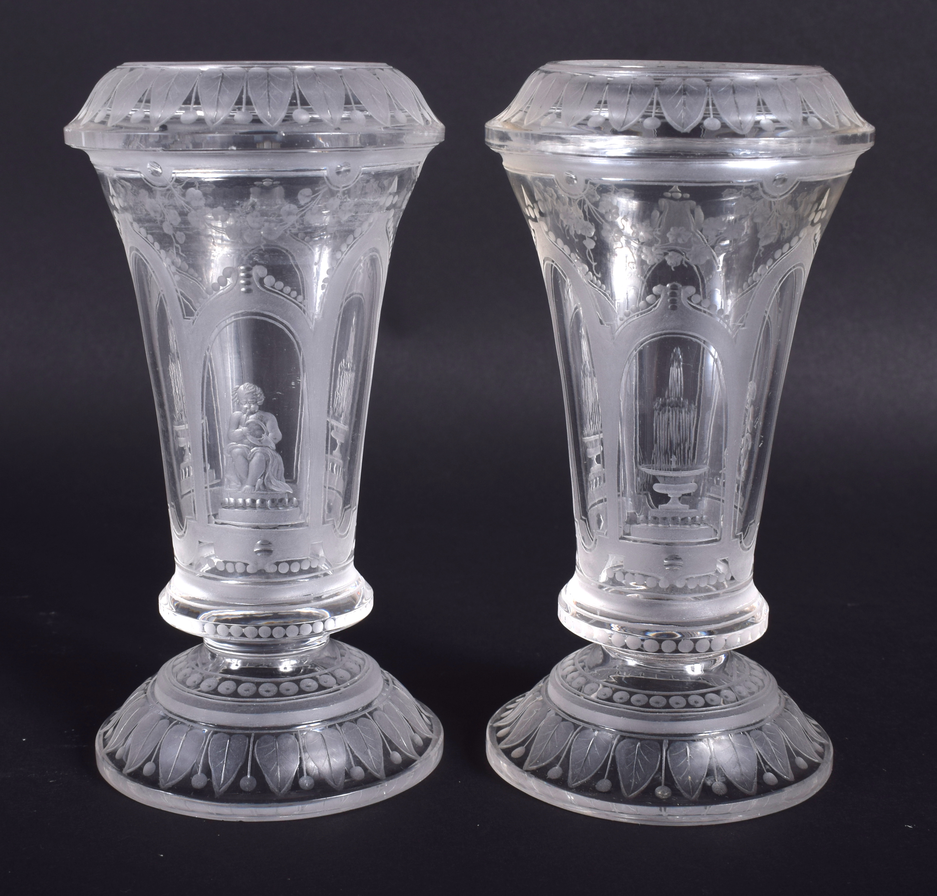 A PAIR OF 19TH CENTURY VENETIAN CLEAR GLASSES etched with figures and buildings. 12.5 cm high.