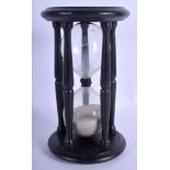 A VINTAGE EBONISED HOUR GLASS. 24 cm high.