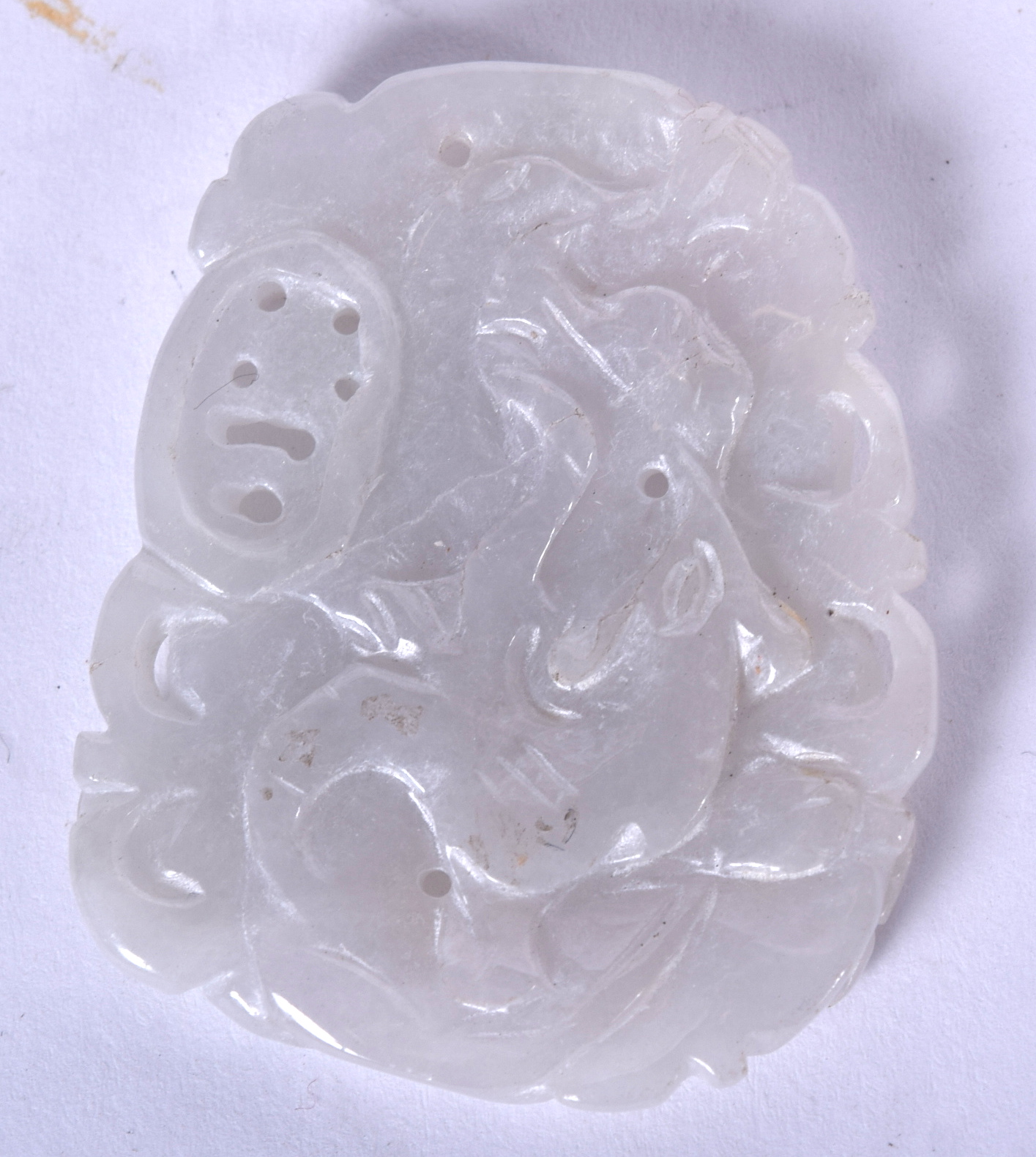 AN EARLY 20TH CENTURY CHINESE CARVED JADE PLAQUE PENDANT, forming mythical creatures amongst foliag - Image 2 of 2