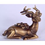 A CHINESE GILT BRONZE FIGURE OF A DEER, modelled with scrolls tied to its back. 8.75 cm wide.