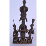 A BENIN BRONZE FIGURE OF A STANDING FEMALE, modelled with an infant suckling her elongated breasts,