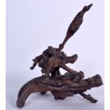 AN EARLY 20TH CENTURY CHINESE ROOT WOOD CARVED GROUP, formed as a bird emerging from the base. 42 c