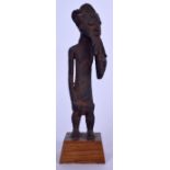 A BENIN BRONZE STATUE OF A MALE, formed standing tugging his beard. 22 cm high.