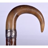 A VICTORIAN RHINOCEROS HORN HANDLED WALKING CANE, formed with a silver collar and naturalistic shaf