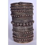 A MIDDLE EASTERN WHITE METAL BANGLE, decorated with extensive bead decoration. 11.5 cm x 7 cm.