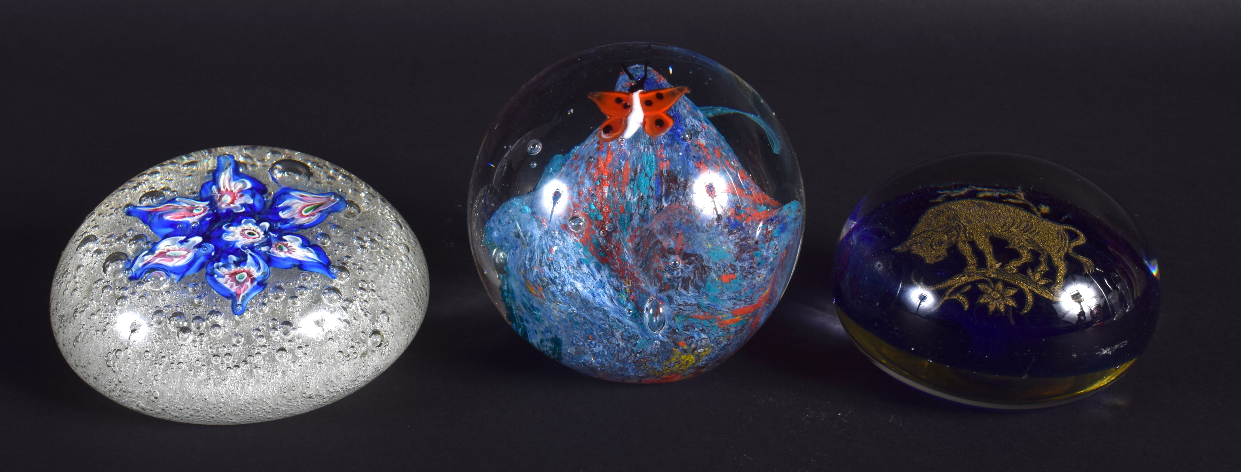 THREE GLASS PAPERWEIGHTS in various forms and sizes. Largest 8.5 cm wide. (3)