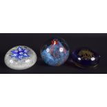 THREE GLASS PAPERWEIGHTS in various forms and sizes. Largest 8.5 cm wide. (3)