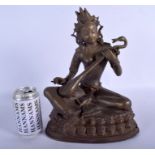 A LARGE 19TH CENTURY INDIAN NEPALESE BRONZE FIGURE OF A SEATED BUDDHA modelled playing an instrumen