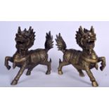 A PAIR OF 20TH CENTURY BRASS STATUE OF MYTHICAL BEASTS, formed with one leg raised. 22 cm wide.
