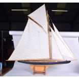 A VINTAGE POND YACHT, with associated wooden stand. Total 118 cm x 117 cm.
