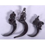 THREE EASTERN WHITE METAL HOOKS, varying design. Largest 6.5 cm long. (3)