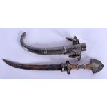 AN ANTIQUE INDIAN MIDDLE EASTERN DAGGER overlaid in white metal scrolling motifs. 41 cm long.