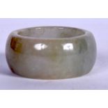 A CHINESE CARVED JADEITE RING. 2.75 cm wide.