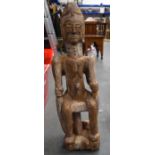 A WEST AFRICAN CARVED TRIBAL STATUE, formed holding a snake in each arm. 77 cm high.