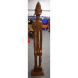 A LARGE AFRICAN CARVED WOODEN STATUE, in the form of an elongated male. 144 cm high.