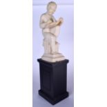 A SCULPTURE OF A YOUNG BOY WRITING IN A BOOK, formed seated upon a plinth. 61 cm high.