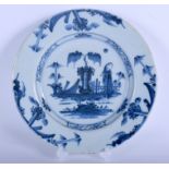 AN 18TH CENTURY DUTCH DELFT BLACK AND WHITE TIN GLAZED DISH painted a figure within a landscape. 22