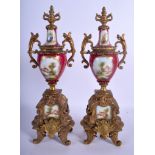 A PAIR OF 19TH CENTURY FRENCH TWIN HANDLED PORCELAIN URNS AND COVERS with gilt metal mounts. 36 cm