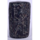 AN UNUSUAL EASTERN HARDSTONE BEAD, carved with figures and symbols. 3.75 cm long.