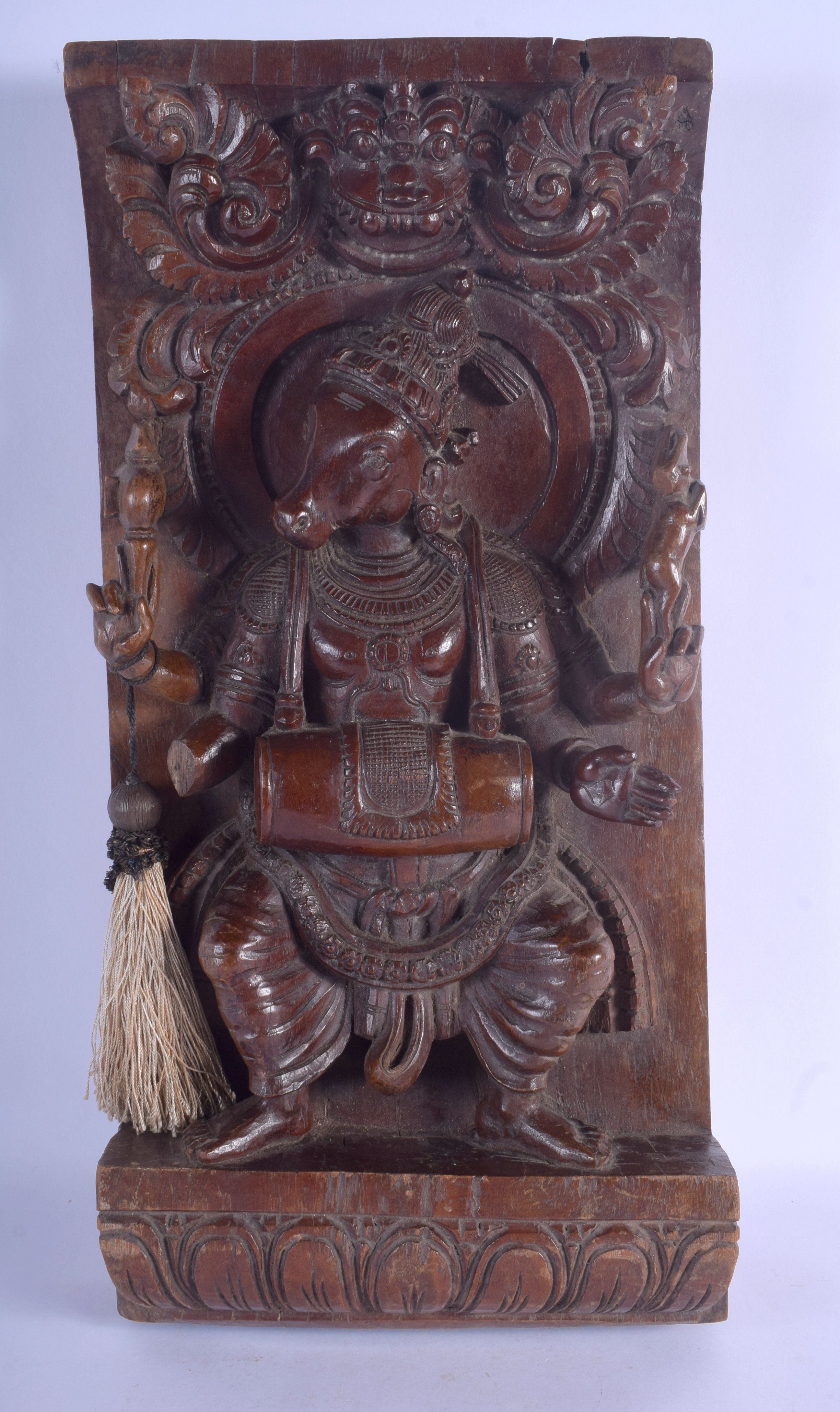 A LOVELY 19TH CENTURY INDIAN CARVED HARDWOOD BUDDHISTIC PANEL depicting deity holding aloft figures