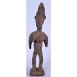 AN IVORY COAST WOODEN FERTILITY FIGURE, in the form of a standing female with elongated breasts. 45