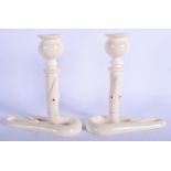 A RARE PAIR OF 1920S CARVED IVORY SERPENT CANDLESTICKS with coral inset eyes. 13 cm x 15 cm.