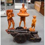 THREE AFRICAN FIGURES, together with a model cannon. (4)
